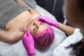 Attractive female at spa health club getting a facial massage. Beautician doing massage of face, neck and shoulders Royalty Free Stock Photo