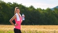 Attractive female taking a break after jogging