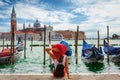 Attractive, female tourist enjoys the view from St. Mark`s Square in Venice, Italy Royalty Free Stock Photo