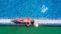 Attractive woman tourist in bikini sunbathes in scorching hot tropical summer. Sexy young woman sleeps on the edge of the crystal Royalty Free Stock Photo