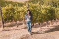 attractive female winemaker posing in her vineyard