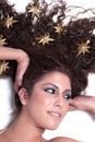 Attractive female woman's face with gold stars on her hair Royalty Free Stock Photo