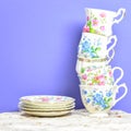 Attractive fine bone china tea cups on a purple background Royalty Free Stock Photo