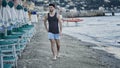 Attractive athletic young man walking on beach Royalty Free Stock Photo