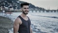 Attractive athletic young man walking on beach Royalty Free Stock Photo