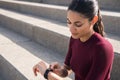 Attractive fit brunette looking at watch