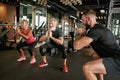 Active elderly woman and man performing squats in gym Royalty Free Stock Photo