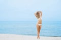 Attractive, fit girl in white bikini posing on the beach Royalty Free Stock Photo
