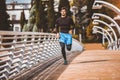 Man running along  modern bridge. Exercising, Jogging, Sport. Male athlete running Royalty Free Stock Photo