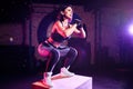 Attractive fit middle age woman doing box jumping at a crossfit style. Female athlete is performing jumps at gym Royalty Free Stock Photo