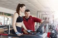 Attractive fit woman having physical activity in gym, fitness woman working out with personal trainer, lady in black sporty wear