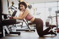 Attractive fit woman relaxing after workout in gym fitness. Portrait sport and Healthy concept