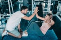 Attractive fitness couple love giving high five together after workout in fitness gym., Portrait of man and woman sporty are Royalty Free Stock Photo
