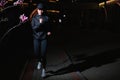 Attractive Fitness Woman in Black Athletic Wear Jogging On Street Alone, Night