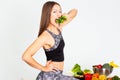 Attractive fitness woman, trained female Fit power athletic confident young woman bodybuilder eating veg , Organic Food. Royalty Free Stock Photo