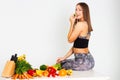 Attractive fitness woman, trained female Fit power athletic confident young woman bodybuilder eating veg , Organic Food. Royalty Free Stock Photo