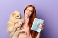 Attractive ginger smiling woman holding a nappy and her pet Royalty Free Stock Photo