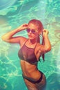 Attractive girl in bikini in pool summer day Royalty Free Stock Photo
