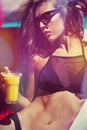 Attractive girl in bikini and sunglasses by pool Royalty Free Stock Photo