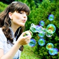 Attractive girl blowing soap bubbles Royalty Free Stock Photo