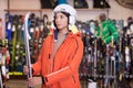 Girl choosing alpine ski in sport goods store