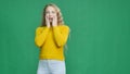 Attractive girl depict shock in camera on green background