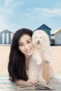 Attractive girl with dog and book at shore Royalty Free Stock Photo