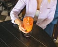 Attractive girl drinking cocktail in a bar or restaurant. Still life, refreshing alcohol drink. Fruit beverage in a bar