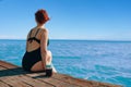 Attractive girl enjoys the sea view on vacation. Royalty Free Stock Photo