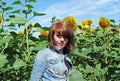 The attractive girl in the field of sunflowers Royalty Free Stock Photo