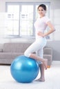 Attractive girl with fitness ball smiling Royalty Free Stock Photo