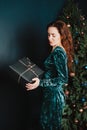 Attractive girl with gift box near Christmas tree Royalty Free Stock Photo