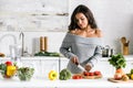 Girl holding knife near cherry tomatoes Royalty Free Stock Photo