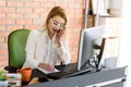 Attractive girl holding mobile while looking at her notebook Royalty Free Stock Photo