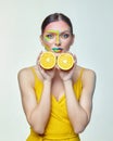 Attractive girl holds orange slices in front of her face Royalty Free Stock Photo