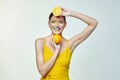 Attractive girl holds orange slices in front of her face Royalty Free Stock Photo