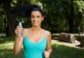 Attractive girl jogging in nature smiling Royalty Free Stock Photo