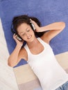 Attractive girl laying on floor enjoying music Royalty Free Stock Photo