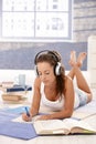 Attractive girl learning at home laying on floor Royalty Free Stock Photo