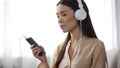 Attractive girl listening music in headphones, loves radio station, enjoyment Royalty Free Stock Photo