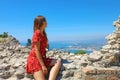 Attractive girl looking at Taormina village from the ruins of the ancient Greek theater in Sicily, Italy Royalty Free Stock Photo