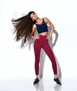 Attractive girl in modern fashionable dark red cherry sportswear make dynamic movement