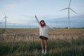 attractive girl with pink hair in white sweater stretching in field Royalty Free Stock Photo