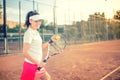 Attractive girl playing tennis and smiling at camera. Healthy modern lifestyle with sportswoman and accesssories