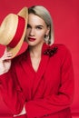 attractive girl in red jacket with boutonniere and straw hat, Royalty Free Stock Photo