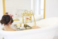 Attractive girl relaxing in bath on light background Royalty Free Stock Photo