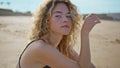 Attractive girl resting sea shore looking camera close up. Woman sitting sand Royalty Free Stock Photo