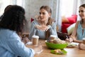 Attractive girl sharing ideas, doing homework with friends in cafe