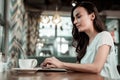 Attractive girl sitting in front of her gadget