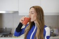 Attractive Girl in Sportswear Drinking Tasty Smoothie